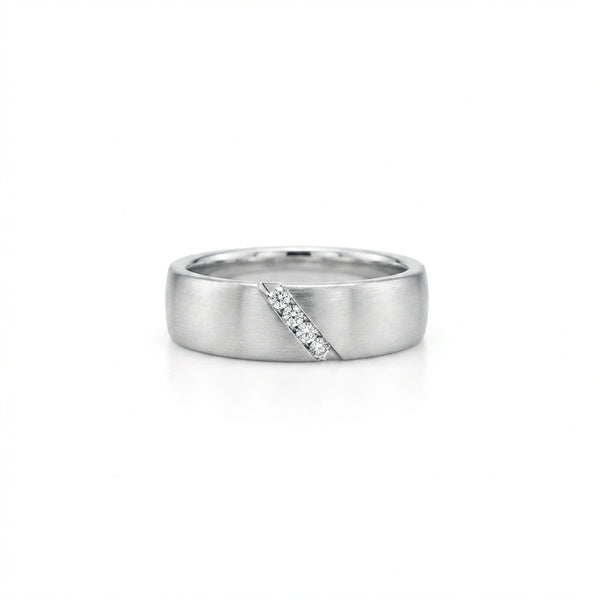 Men’s diamond wedding band in 14K white gold with diagonal channel set round diamonds and matte brushed surface