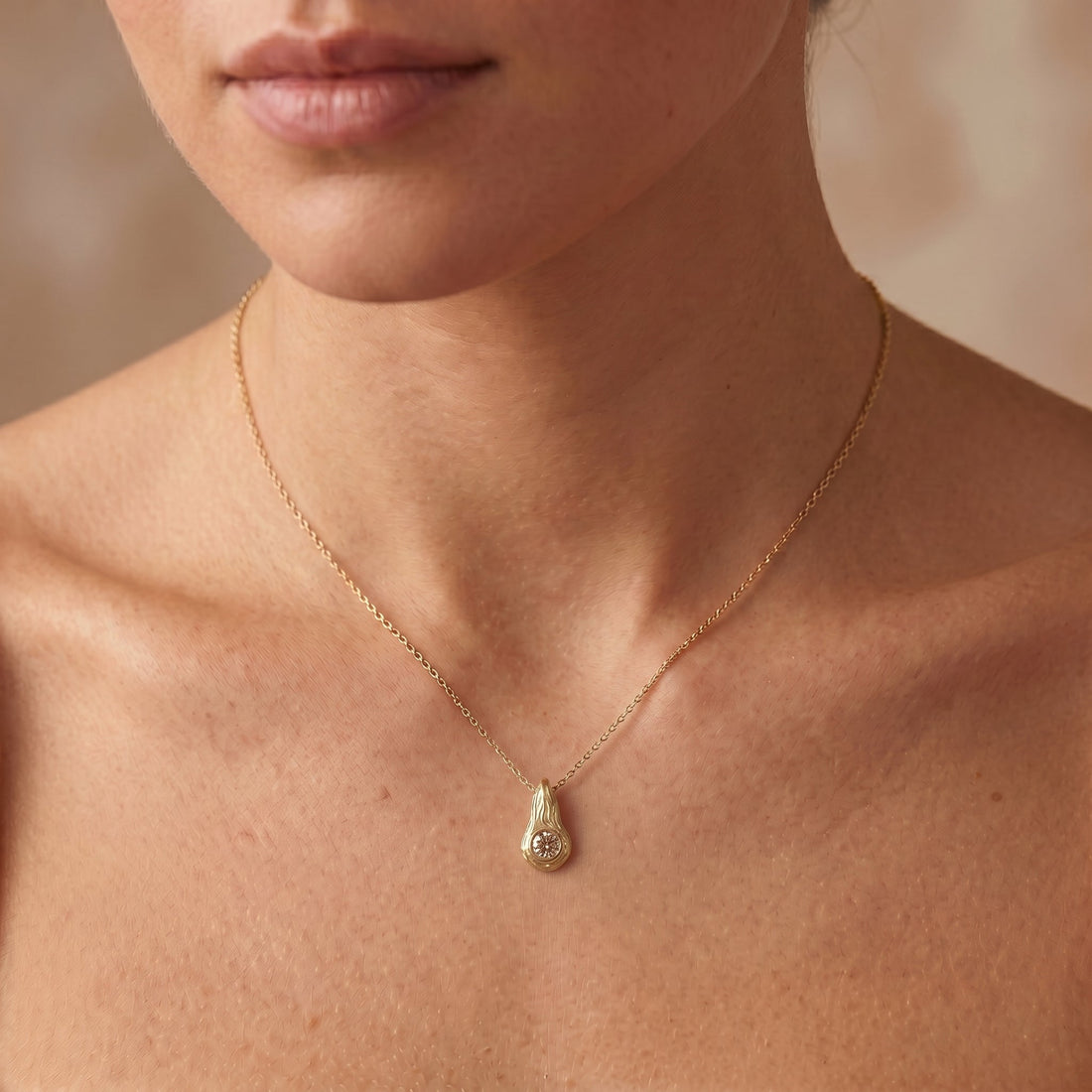 Champagne diamond Ember pendant in 14K yellow gold worn on the neck, hand-carved flame design