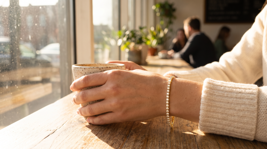 Lab-grown diamond tennis bracelet in 14K yellow gold worn on a wrist in morning light