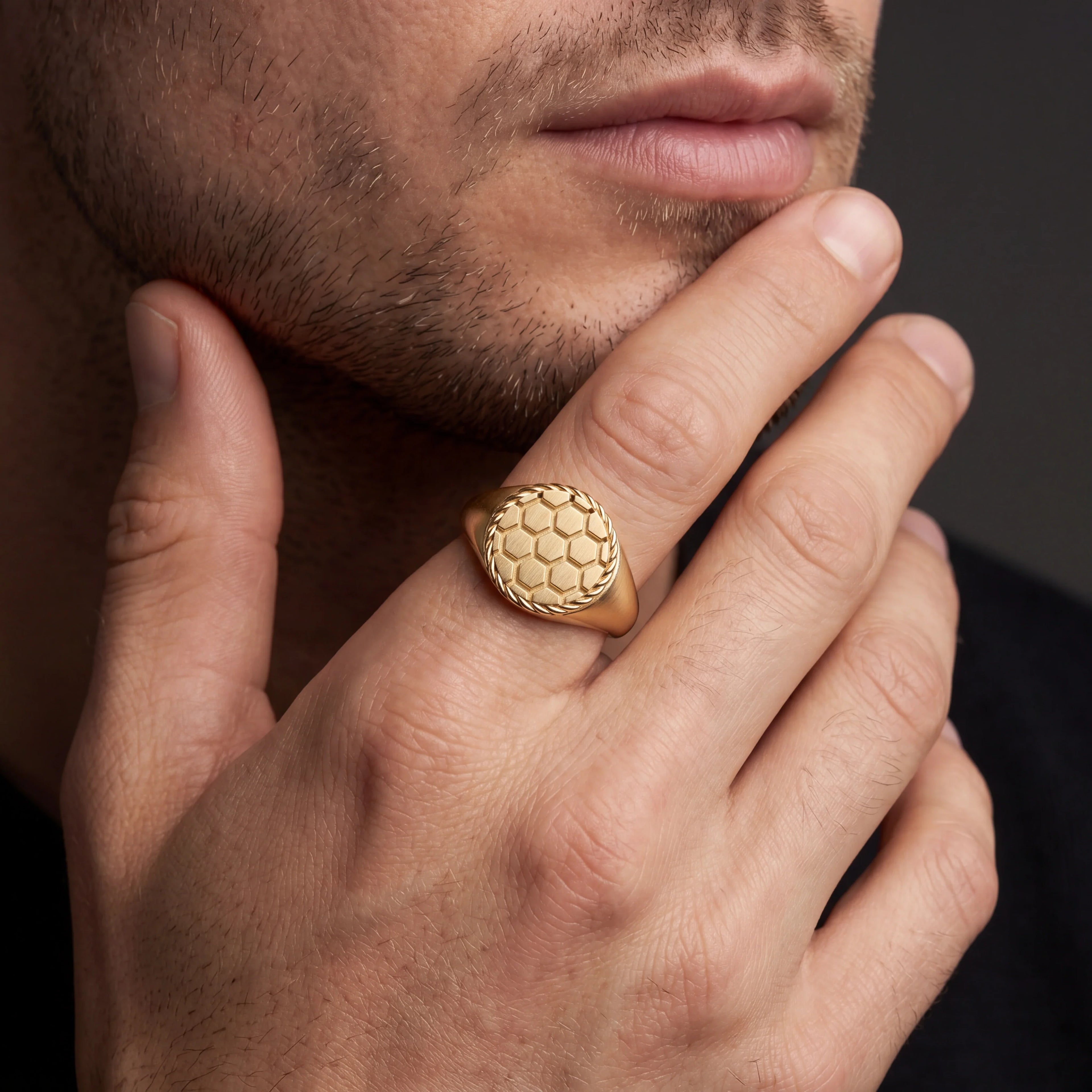 Solid 14K gold honeycomb signet ring on a man's hand — Black Pearl of Queens