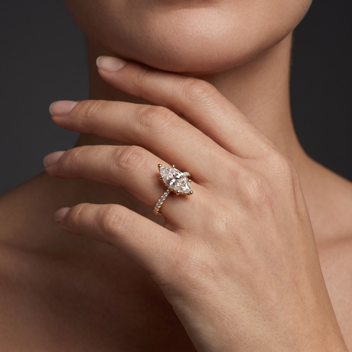 1.5 carat marquise cut Lab-Grown Diamond engagement ring worn on hand, 14K rose gold with pavé band, shown for scale