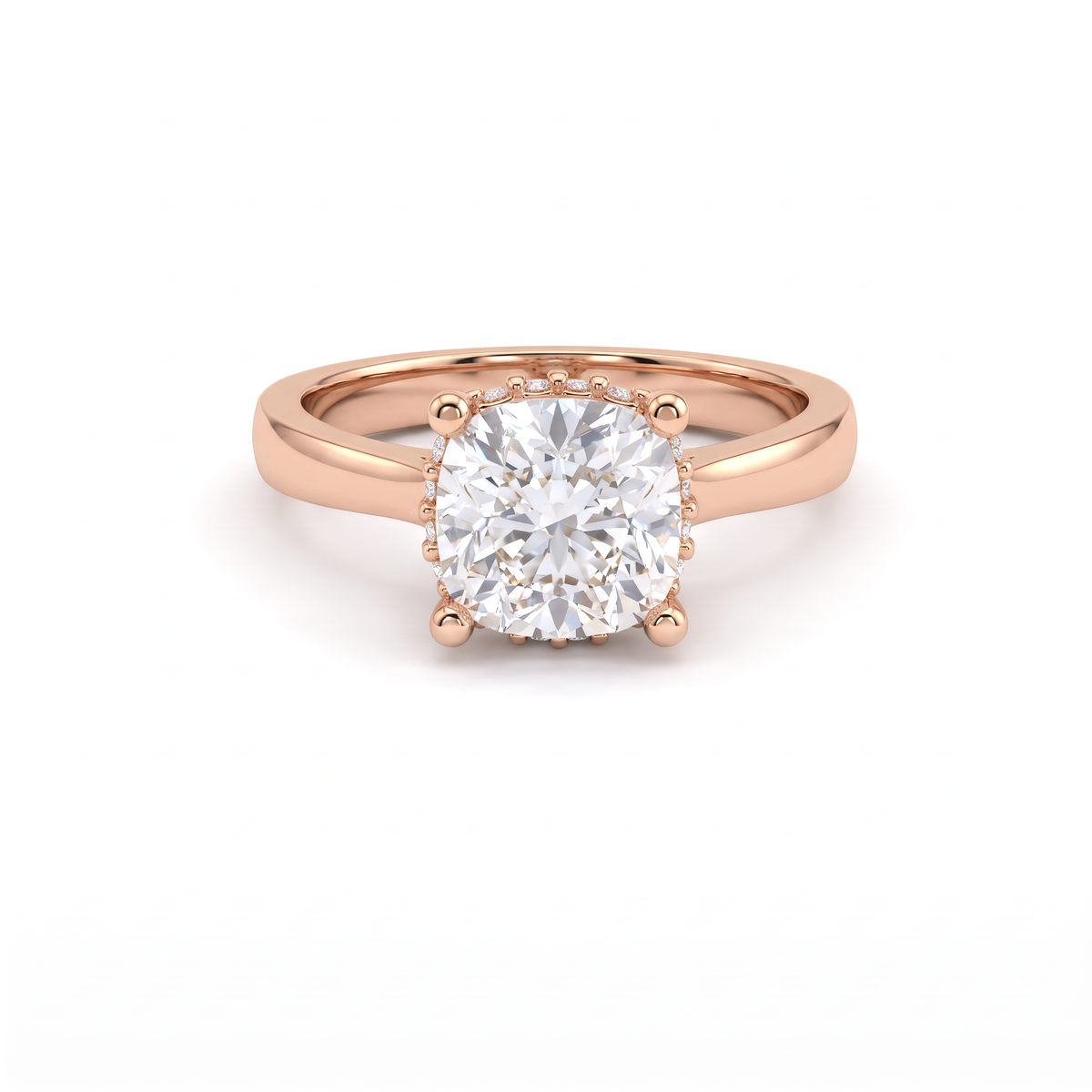1.5ct cushion cut diamond with hidden halo in 14K rose gold, front view, four-prong head on a 2.5mm shank