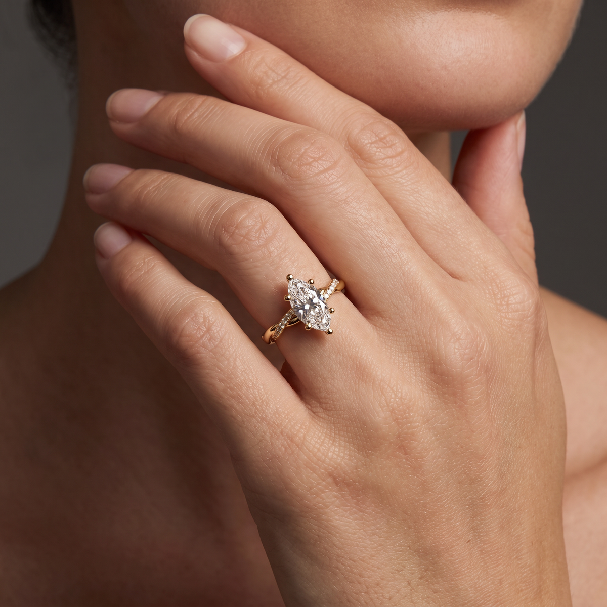 1.5ct marquise twist engagement ring in 14K rose gold worn on the hand