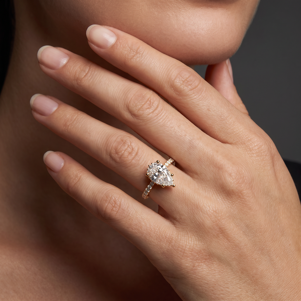 1.5ct Pear Cut Lab-Grown Diamond engagement ring worn on the hand, showing the 14K gold pavé band on the finger