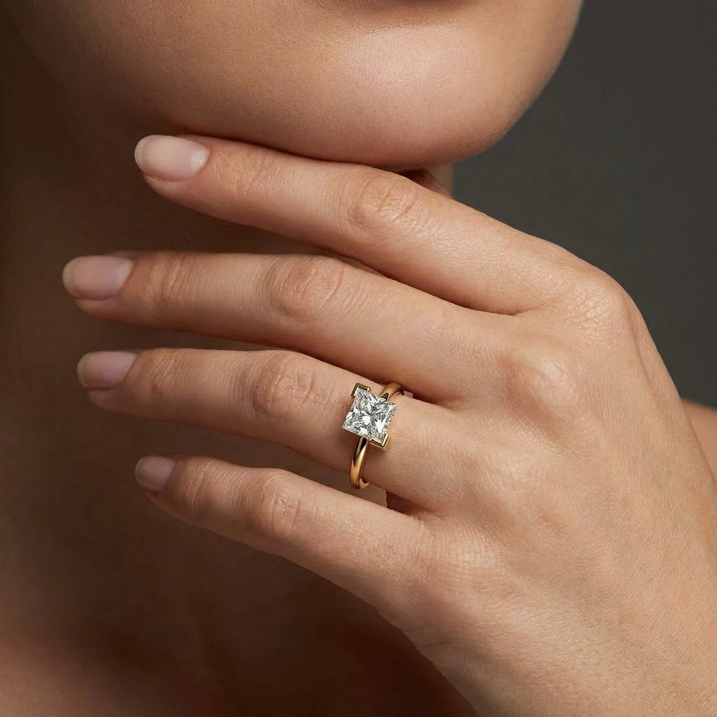 Woman wearing 1 Carat Princess Cut Floating Diamond Ring in 14K yellow gold with floating solitaire diamond