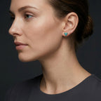Woman wearing 14K gold turquoise stud earrings styled in refined side profile portrait