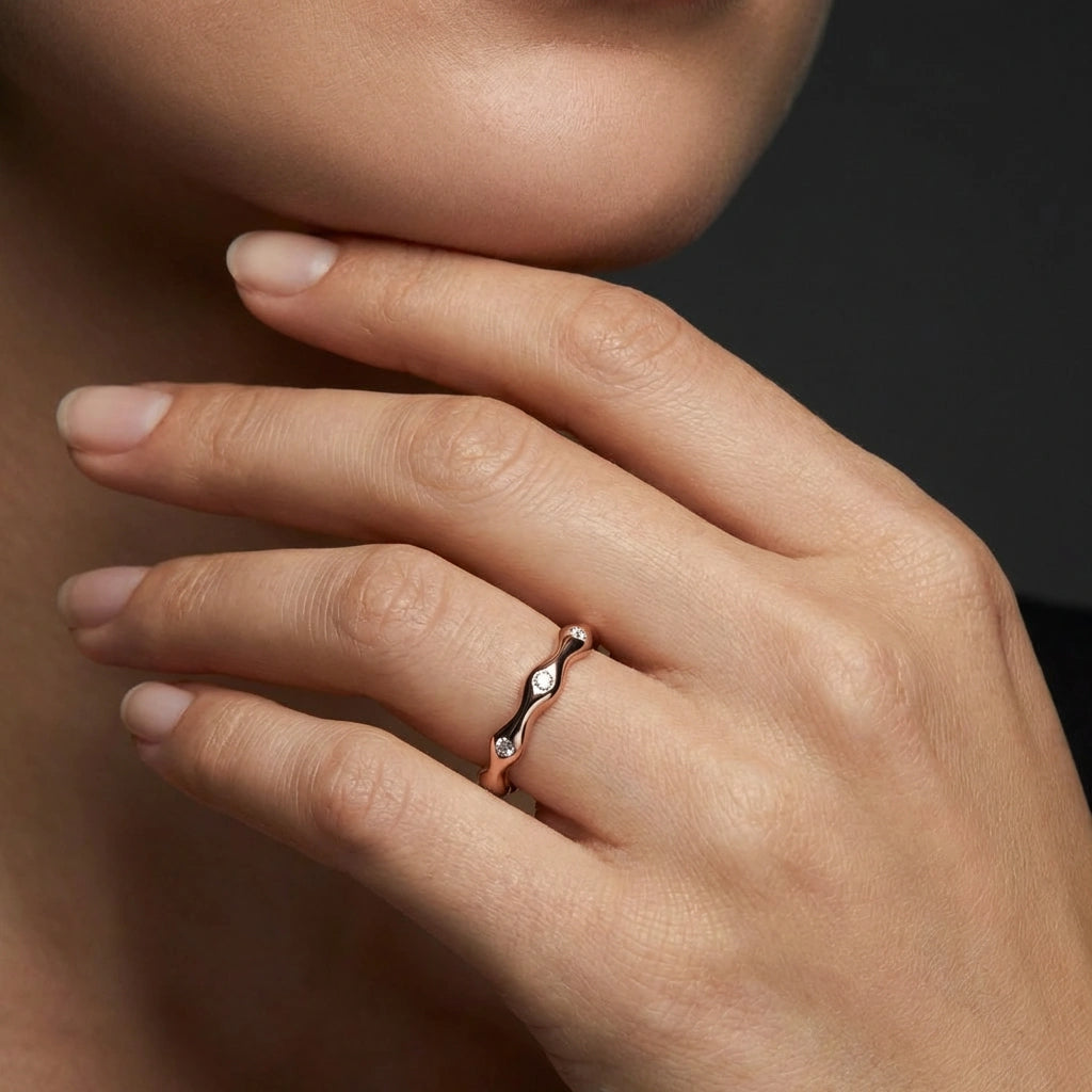 14K rose gold curved diamond band ring close-up on hand