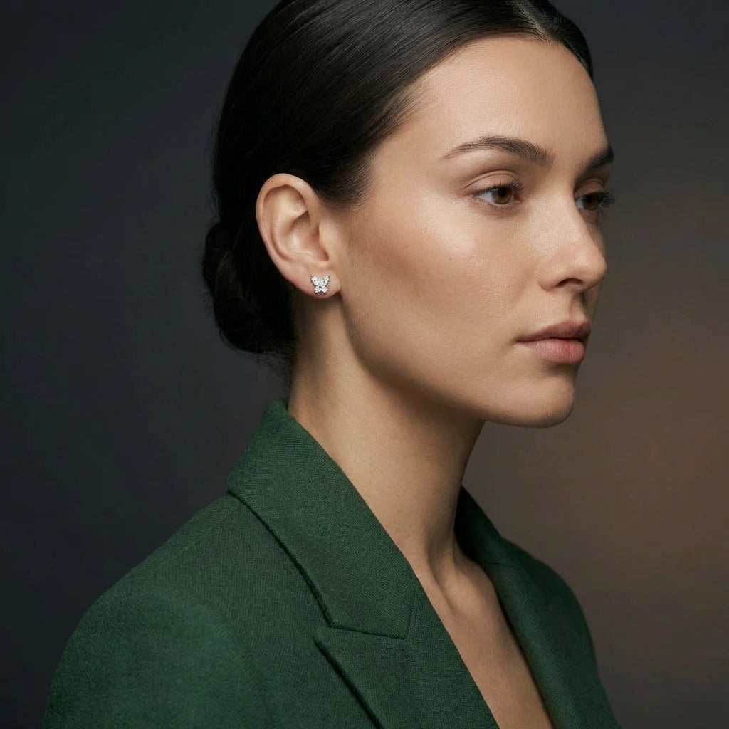 Woman wearing 14K white gold diamond butterfly stud earrings in profile view
