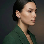 Woman wearing 14K white gold diamond butterfly stud earrings in profile view