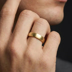 Close-up detail of 5mm 14K yellow gold brushed low dome wedding band texture