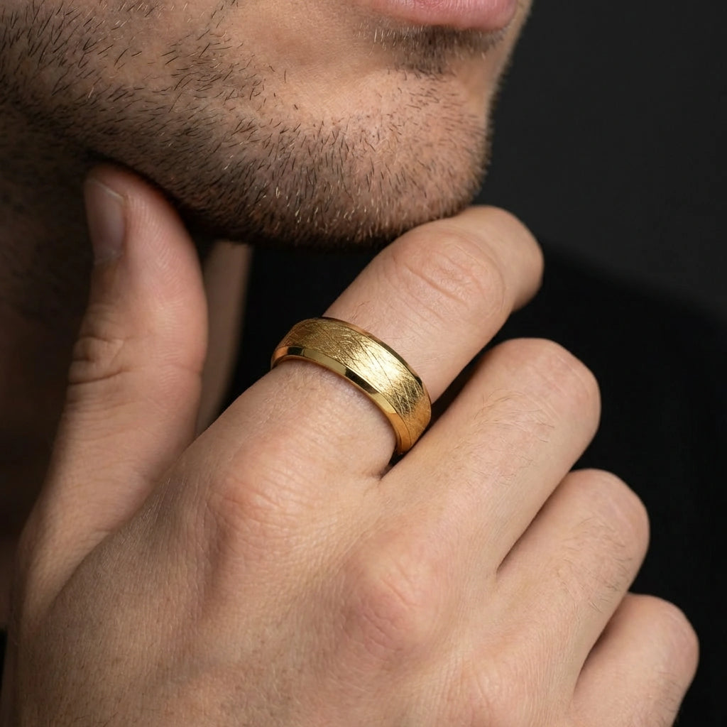 Close-up of 14K yellow gold cross hatched textured wedding band on hand