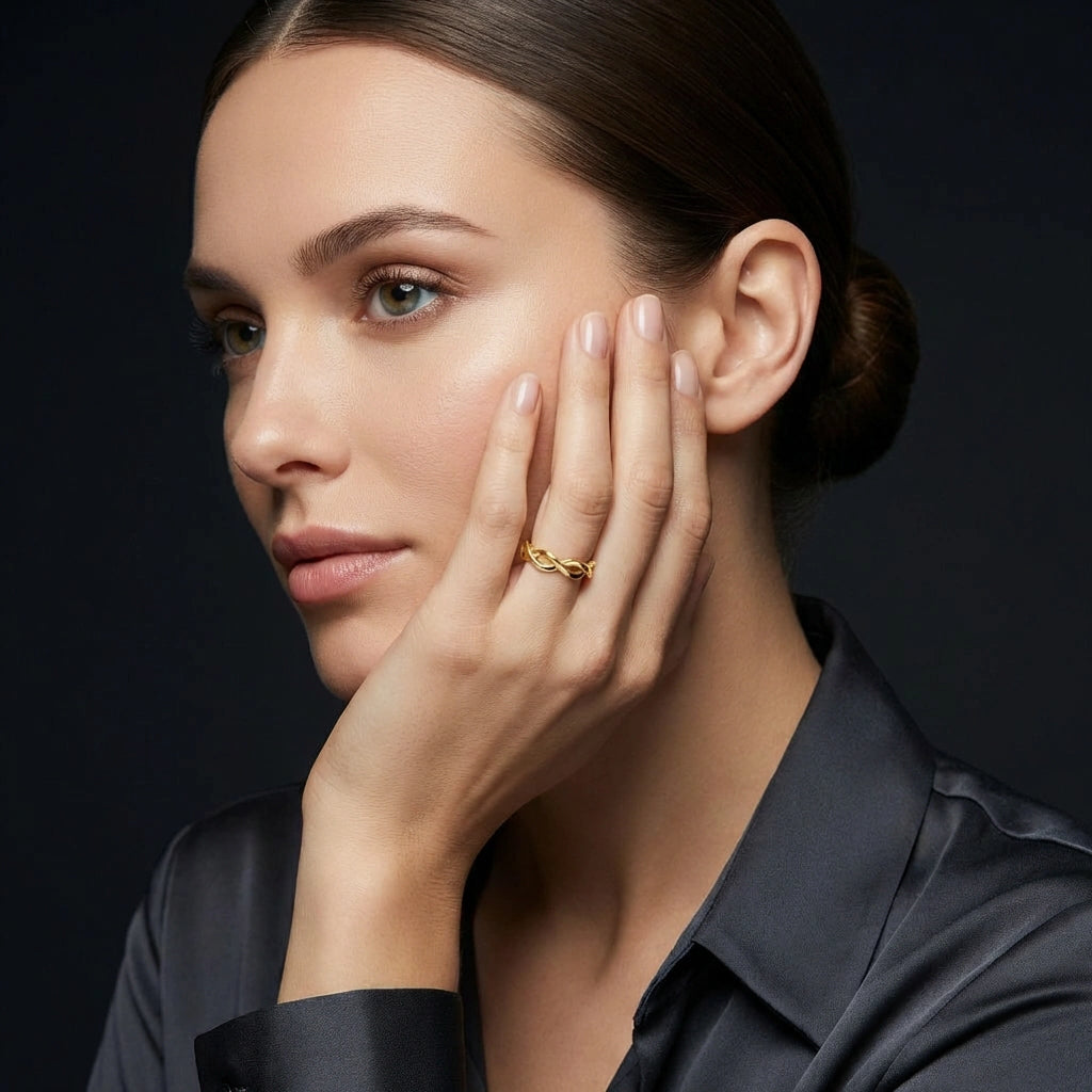 Woman wearing 14K yellow gold twist infinity style ring in portrait view