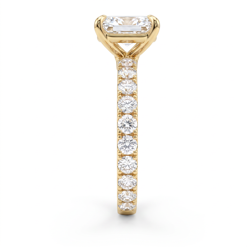 Side profile of 1ct emerald cut French pave engagement ring in 14K yellow gold showing minimal metal between the stones