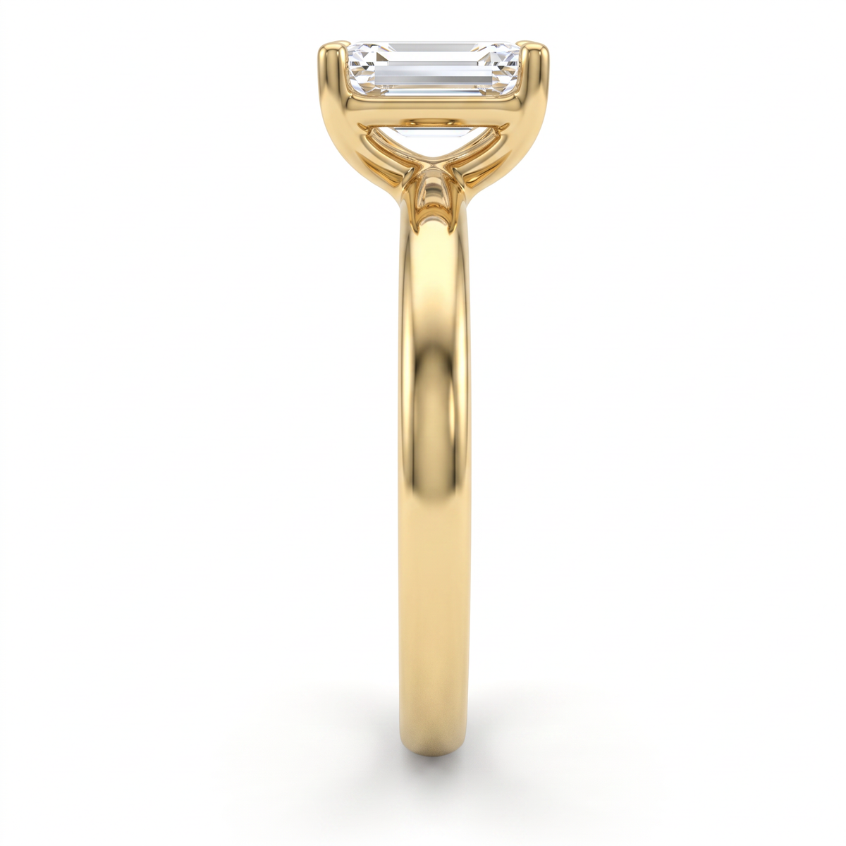 Side profile of 1ct emerald cut solitaire engagement ring in 14K yellow gold showing low setting height