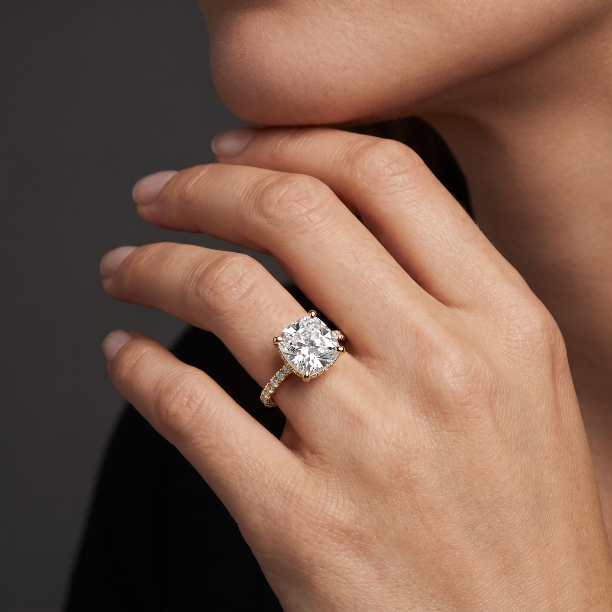 2.5 carat cushion cut Lab-Grown Diamond engagement ring worn on hand, 14K rose gold with pavé band, shown for scale