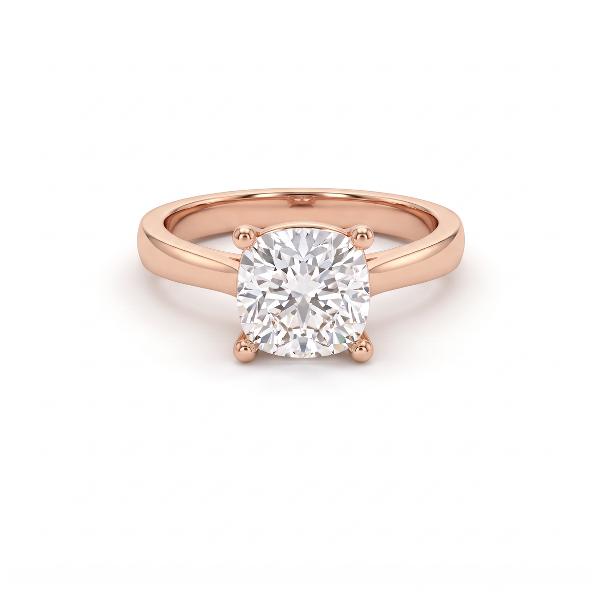 2.5ct cushion cut diamond solitaire in 14K rose gold, front view, four-prong head on a 2.5mm shank