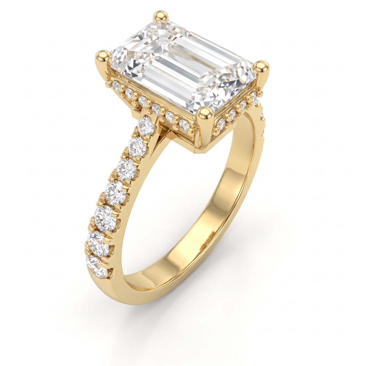 2.5ct emerald cut Lab-Grown Diamond engagement ring in 14K yellow gold, angled view showing four-prong setting and pavé shoulders