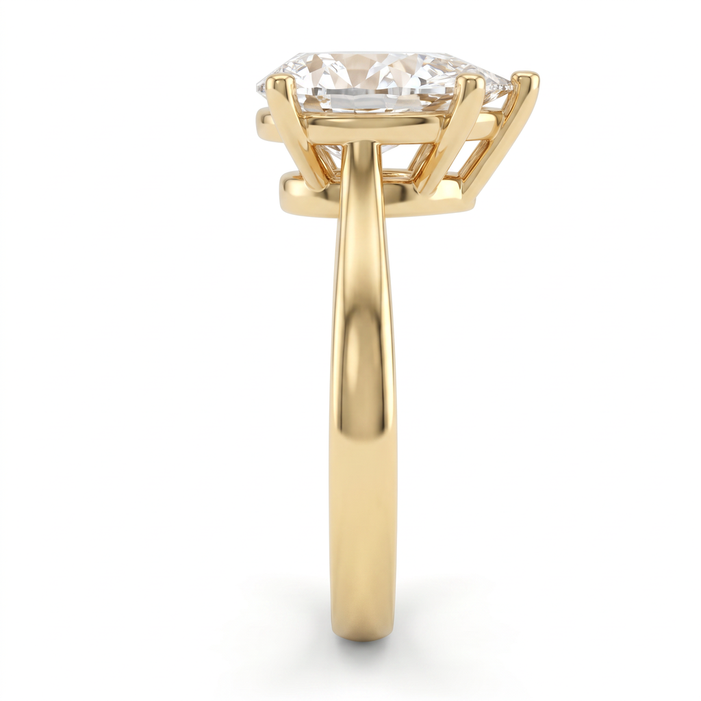 2.5ct pear solitaire in 14K yellow gold viewed along the 2.5mm shank, basket and gallery visible from the side