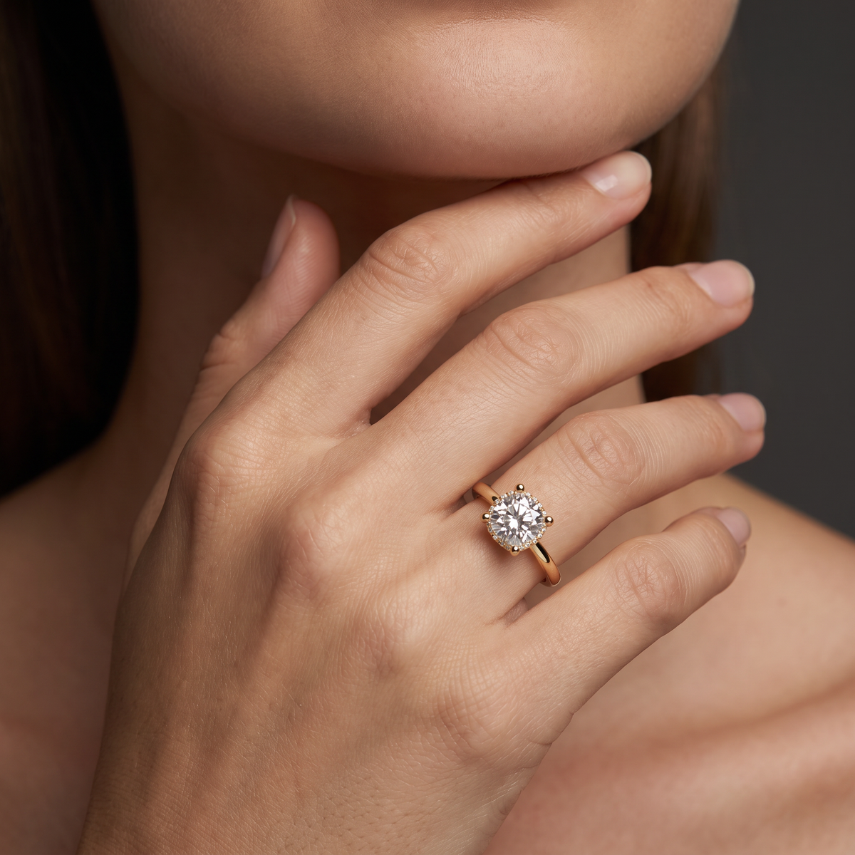 2ct cushion hidden halo engagement ring in 14K yellow gold worn on the hand