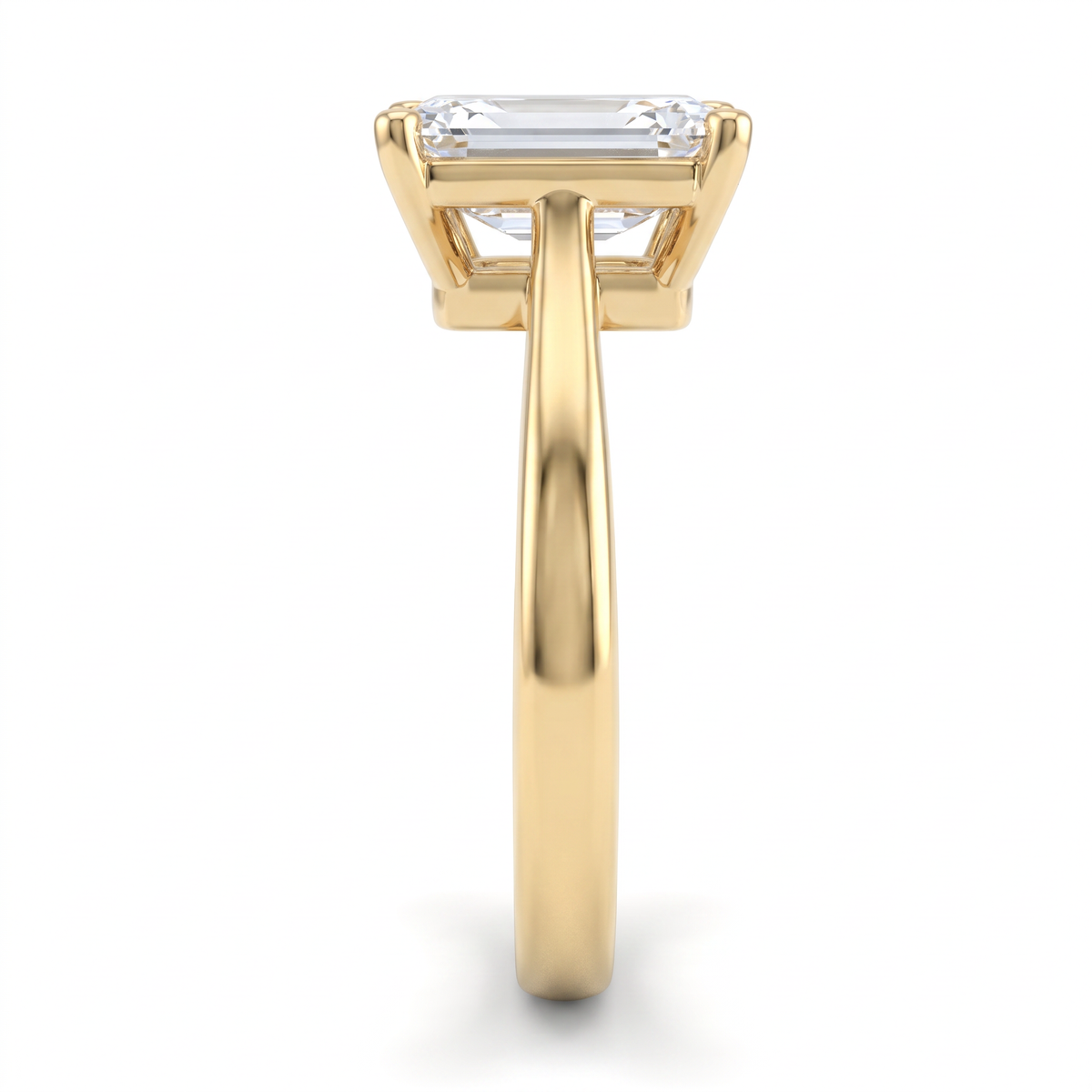 2ct emerald cut solitaire in 14K yellow gold viewed along the 2.5mm shank, basket and gallery visible from the side