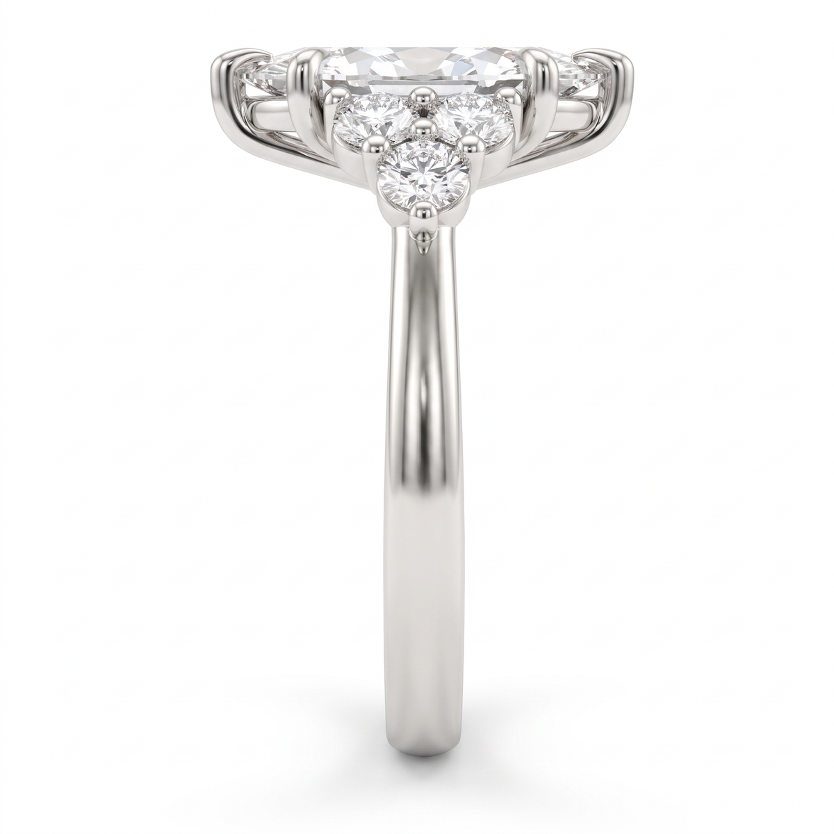 Side profile of a 2ct marquise claw prong engagement ring showing the three-stone round diamond cluster and 14K white gold band