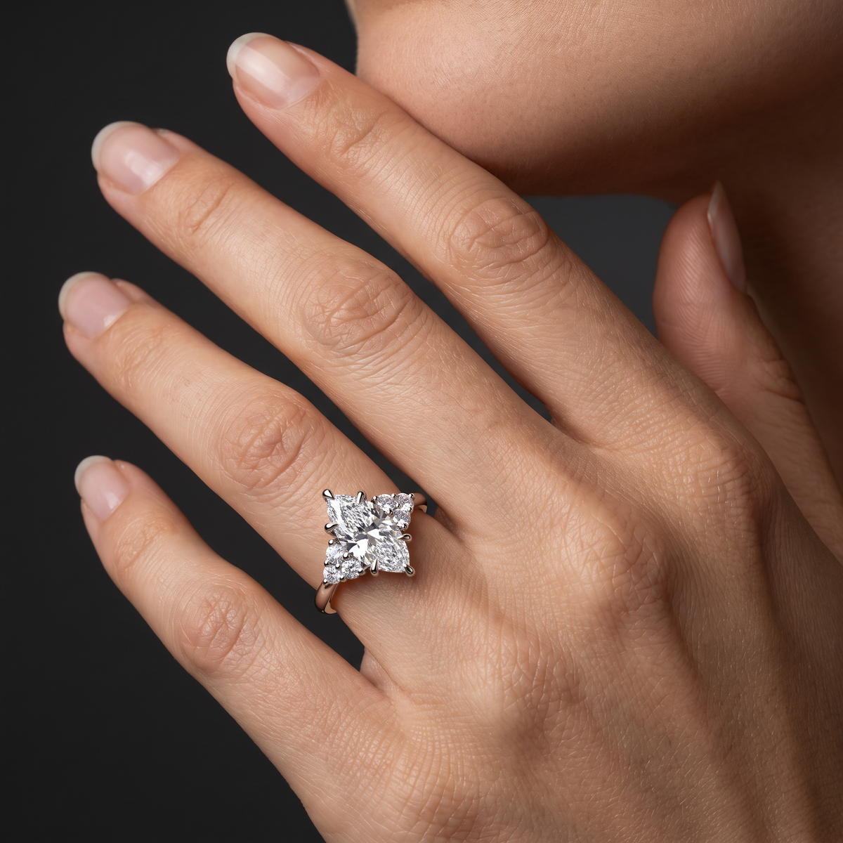 2ct marquise claw prong engagement ring with Lab-Grown Diamond cluster side stones worn on the hand