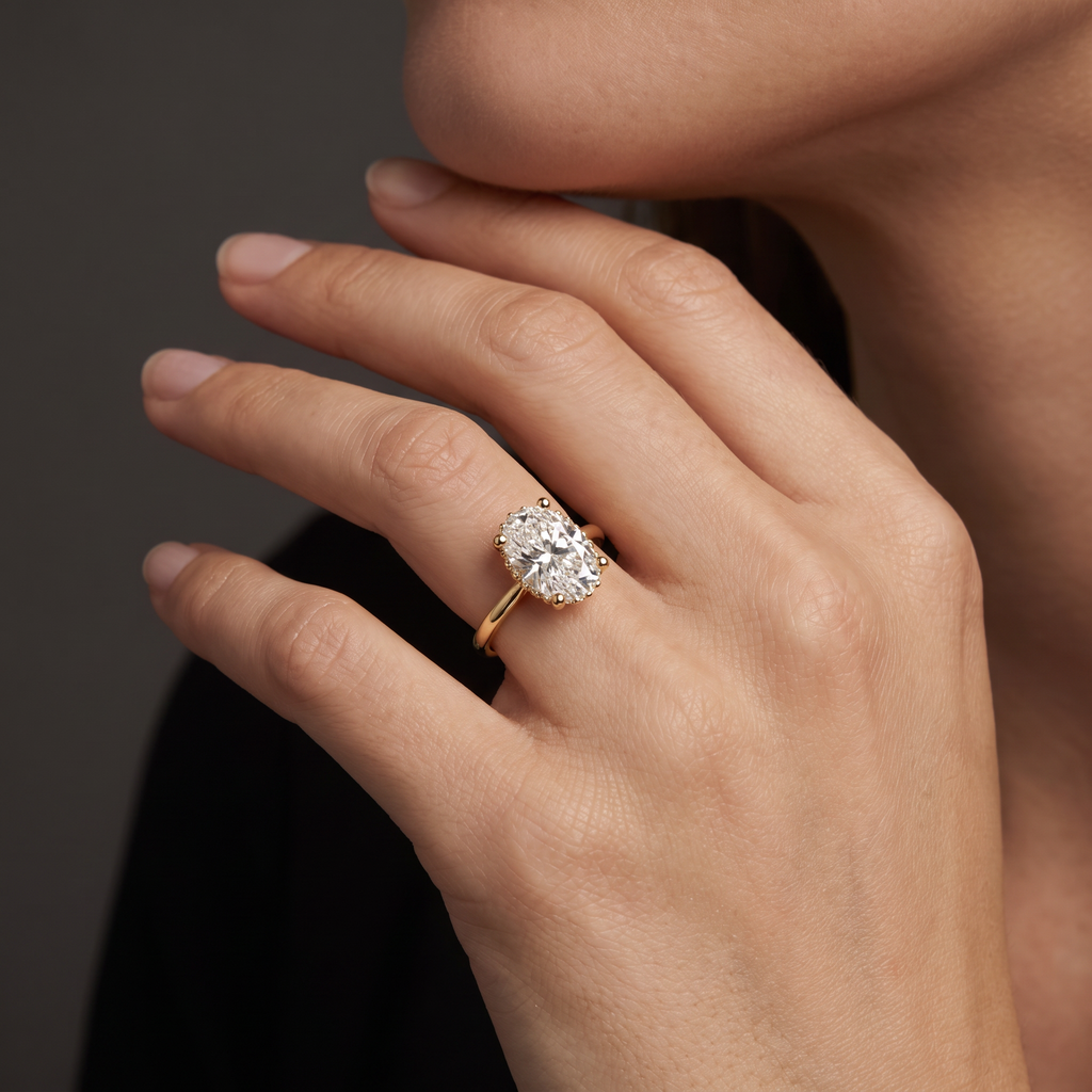 2 carat oval Lab-Grown Diamond hidden halo engagement ring worn on the hand, 14K yellow gold