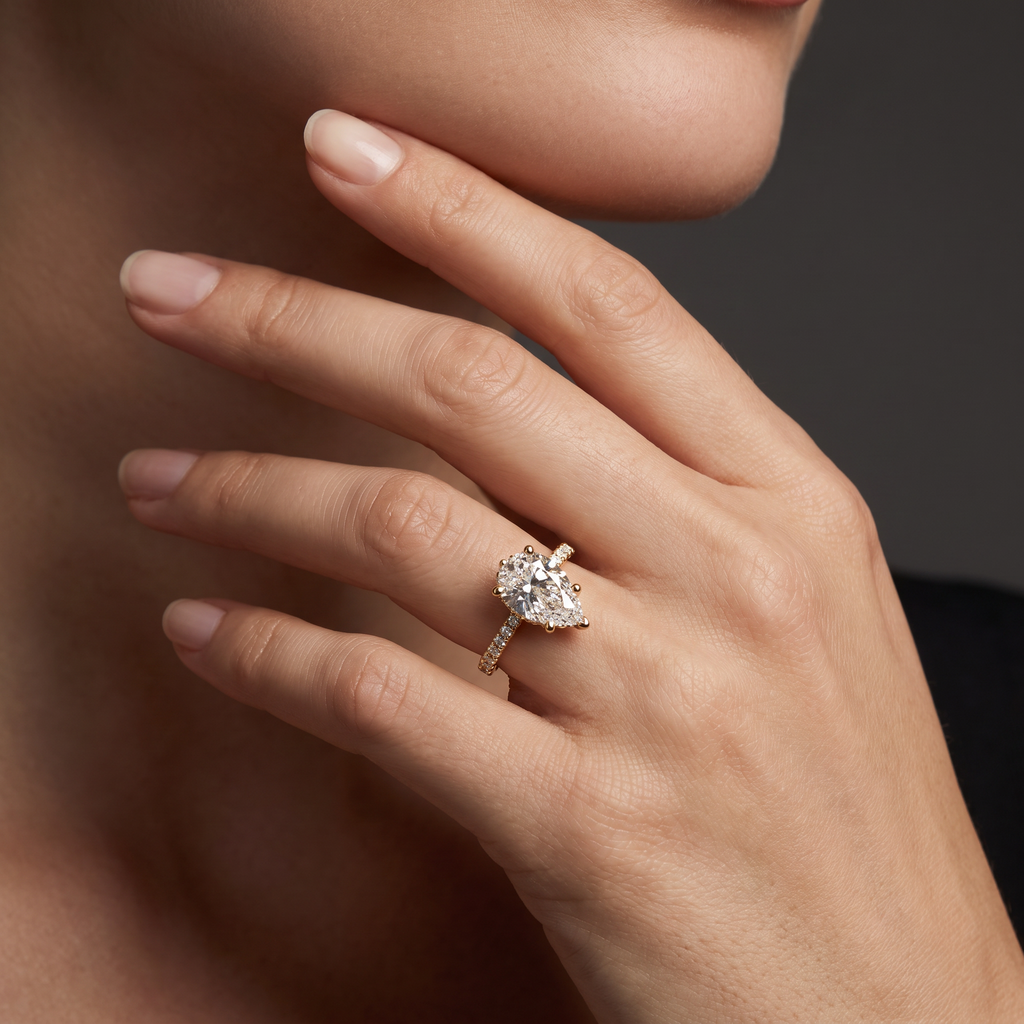 2ct Pear Cut Lab-Grown Diamond engagement ring worn on the hand, showing the 14K gold pavé band on the finger