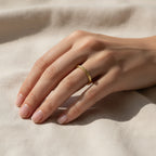 2mm hammered gold wedding band worn on hand