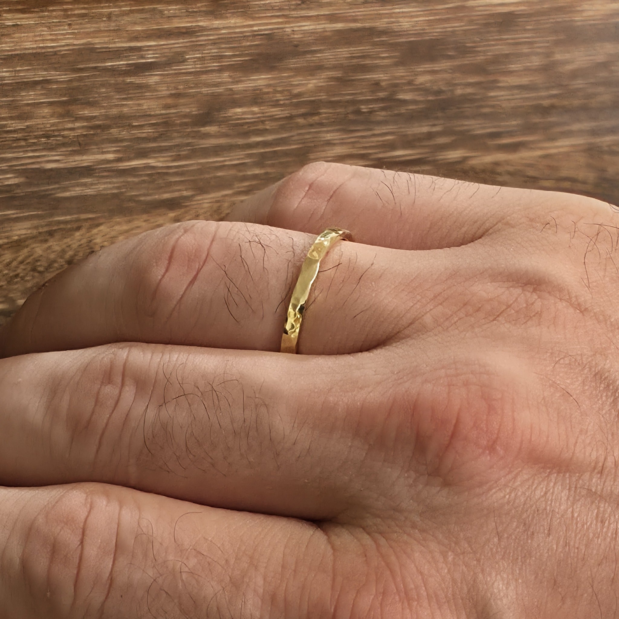 2mm hammered wedding band on mans hand