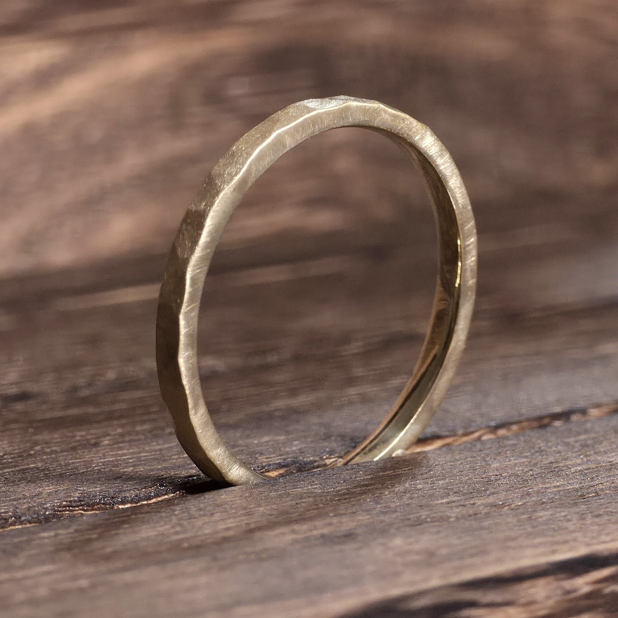 Side view of 2mm hammered gold wedding ring with organic matte finish, modern handcrafted band from Black Pearl of Queens.