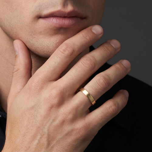 Man wearing the 4mm flat satin wedding band in 14K yellow gold