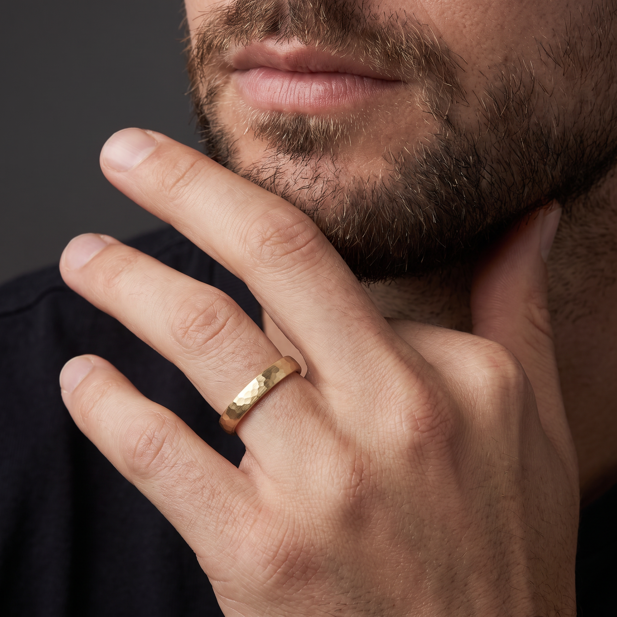 Man wearing the 4mm hammered satin wedding band in 14K yellow gold
