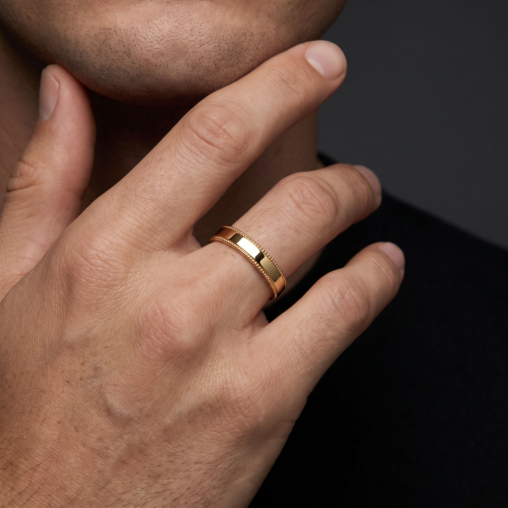 Man wearing the 4mm milgrain wedding band in 14K rose gold