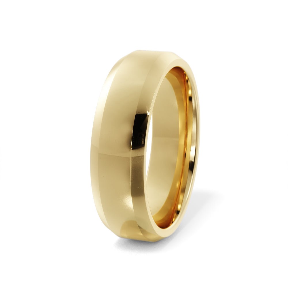 Angled view of a 6mm beveled edge men’s wedding band in 14K gold