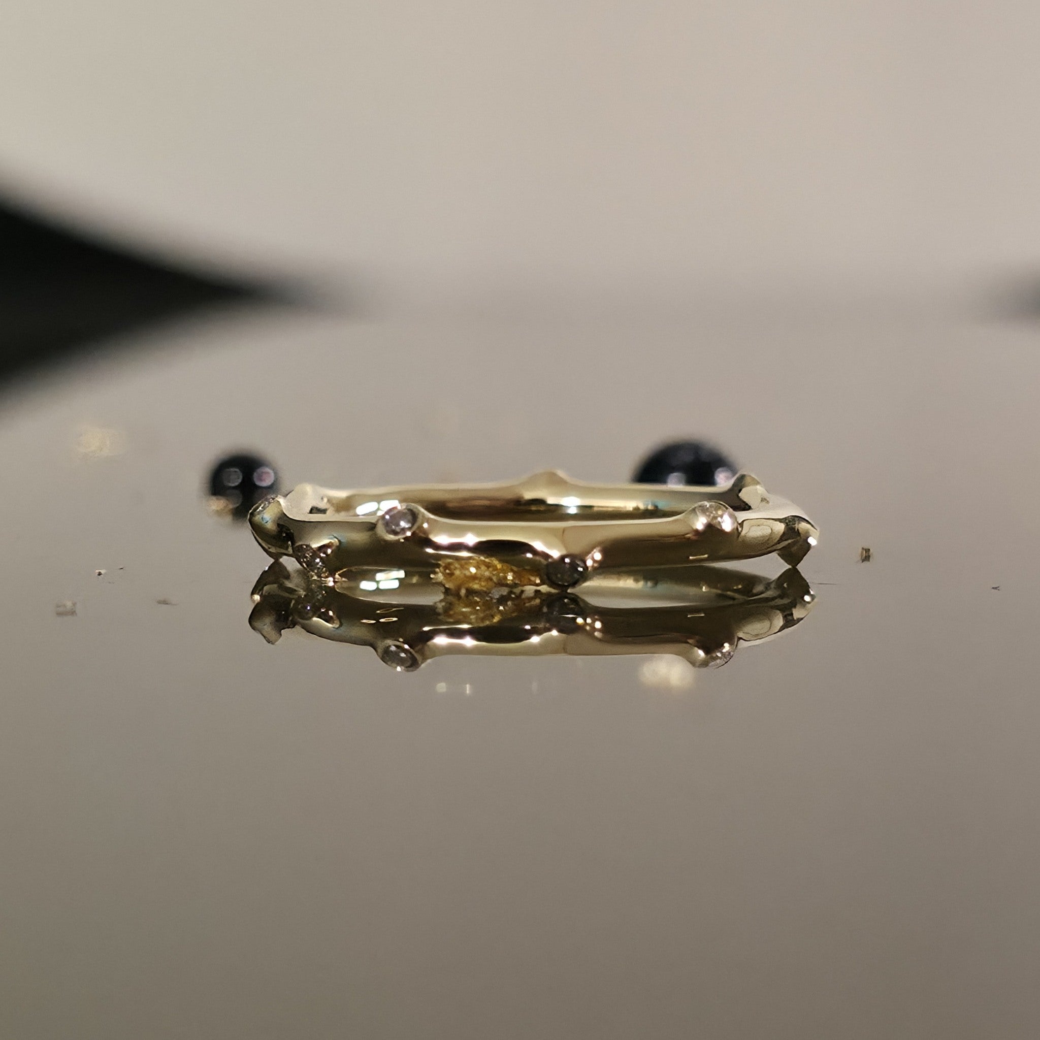Bamboo Diamond Ring Gold in 14K, bamboo-inspired band with organic curves and petite diamonds on mirrored surface.