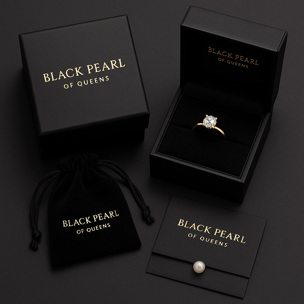 Jewelry set with ring, pearl, and packaging from 'Black Pearl of Queens' on a dark background.
