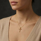 Woman wearing 14K gold Faithline cross necklace with delicate beveled pendant on collarbone
