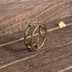 Side view of 14K gold olive leaf band showing smooth openwork design