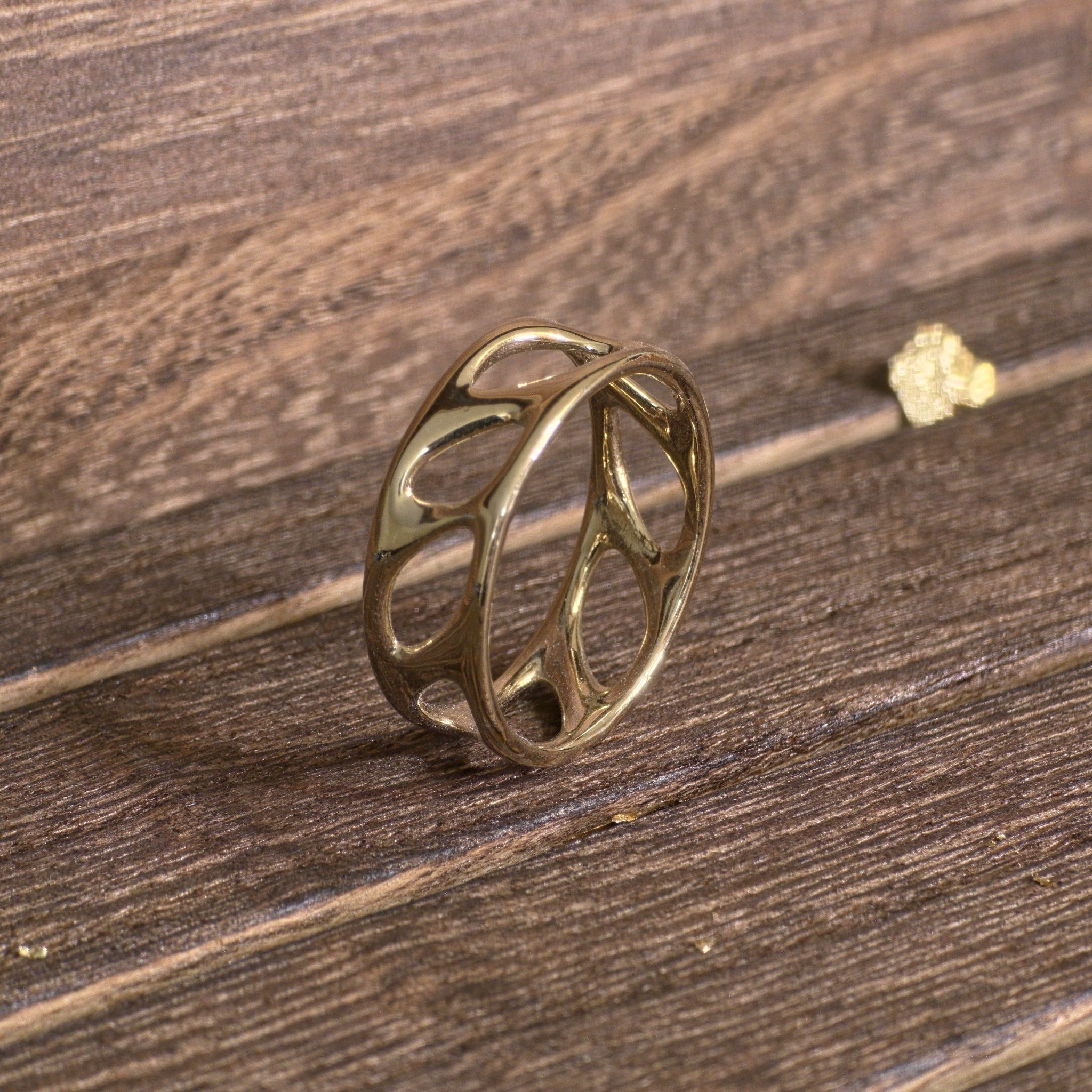 Side view of 14K gold olive leaf band showing smooth openwork design
