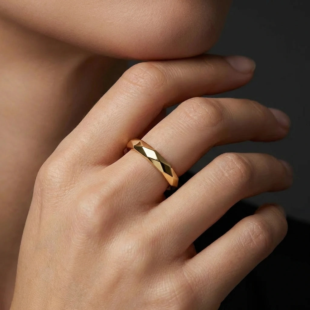 Apex Facet gold band 14K yellow gold faceted ring on finger close up