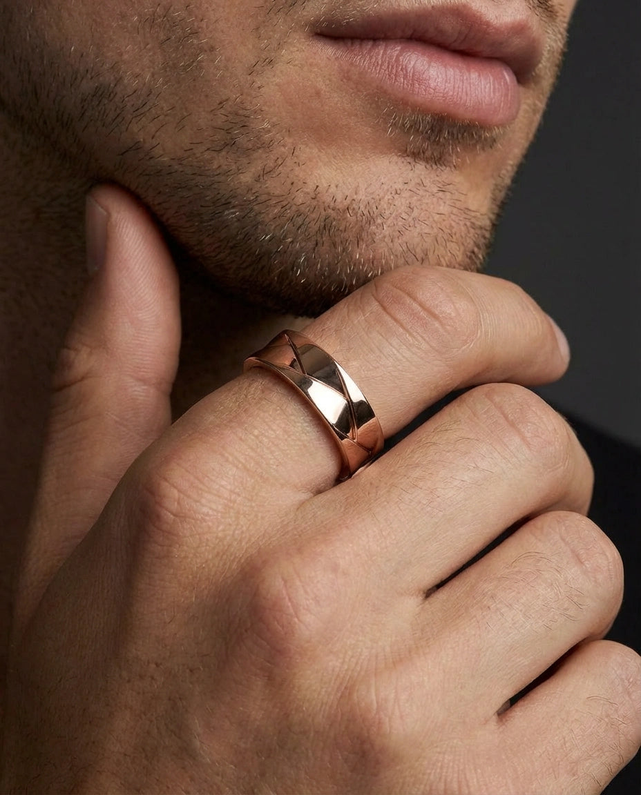 Man wearing Apex interlock facet band with sharp angular pattern and polished finish