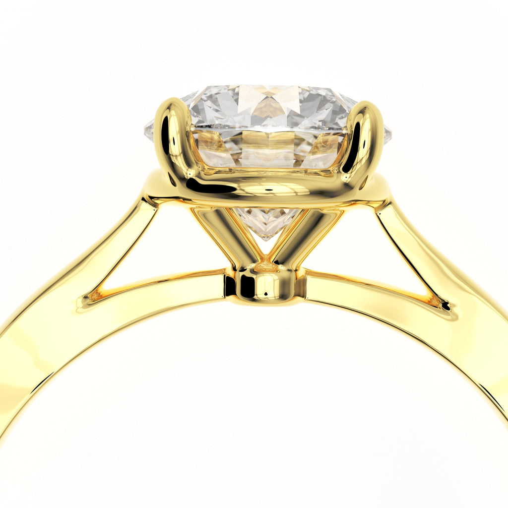 Close-up of cathedral arches and prong setting on 1.5ct round diamond solitaire ring in 14k yellow gold