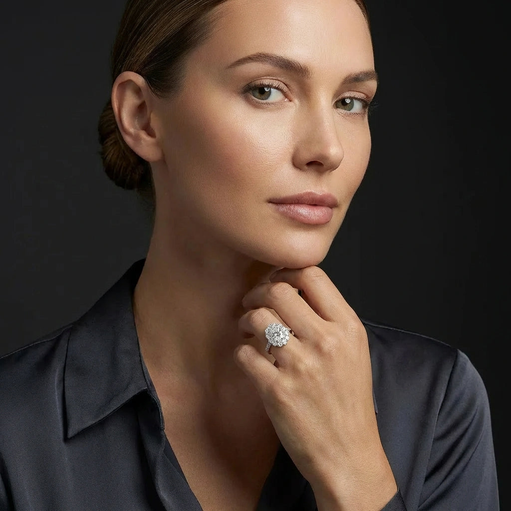 Elegant woman wearing Aurelia Bloom oval diamond engagement ring, luxury floral halo ring on finger