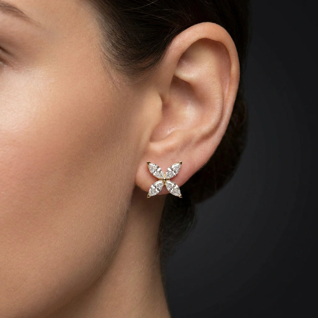 Woman wearing Aurelia marquise diamond flower stud earrings in gold elegant everyday diamond studs