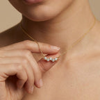 Aurelia Wave Diamond Bar Necklace worn by female model - showing elegant diamond wave pendant at collarbone.