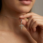 Model wearing Aurex Aquarius Zodiac Necklace in 14K white gold at décolletage, close-up editorial portrait