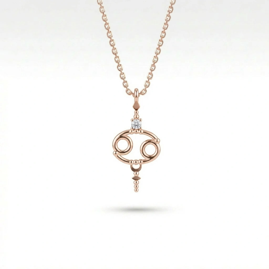 Aurex Cancer Zodiac Diamond Necklace in 14K rose gold, front view showing open oval Cancer symbol with diamond crown and beaded accents on cable chain