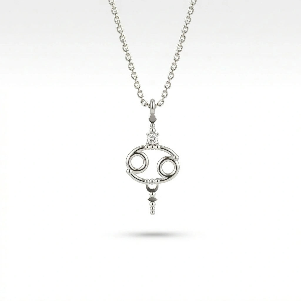 Aurex Cancer Zodiac Diamond Necklace in 14K white gold, front view showing open oval Cancer symbol with diamond crown and beaded accents on cable chain