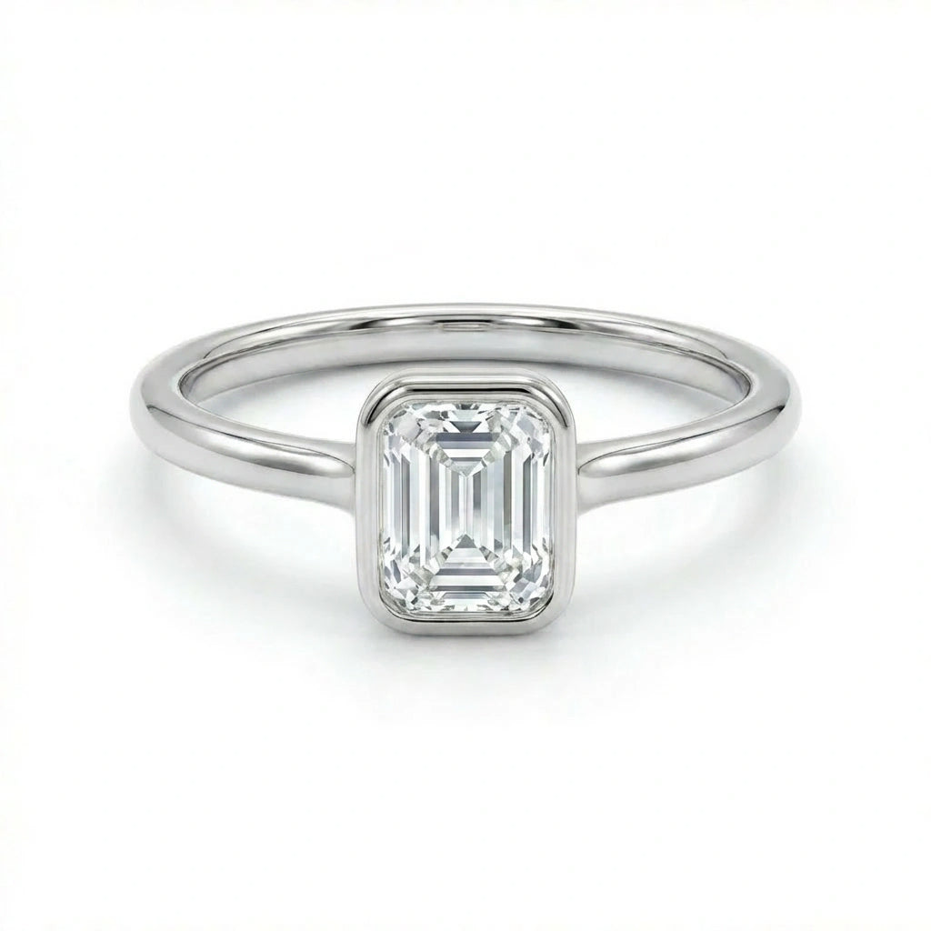 Solid 14K white gold emerald cut diamond ring with clean bezel setting and minimalist band